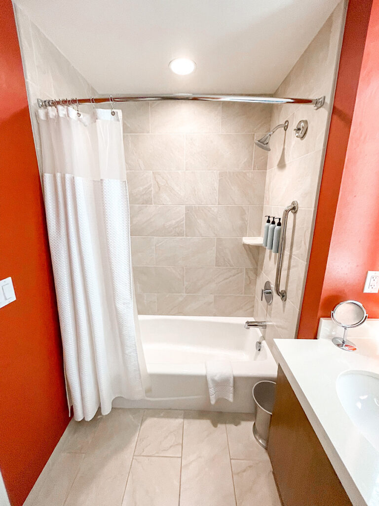 Shower and tub combination in a guest room at Courtyard Anaheim Theme Park Entrance.