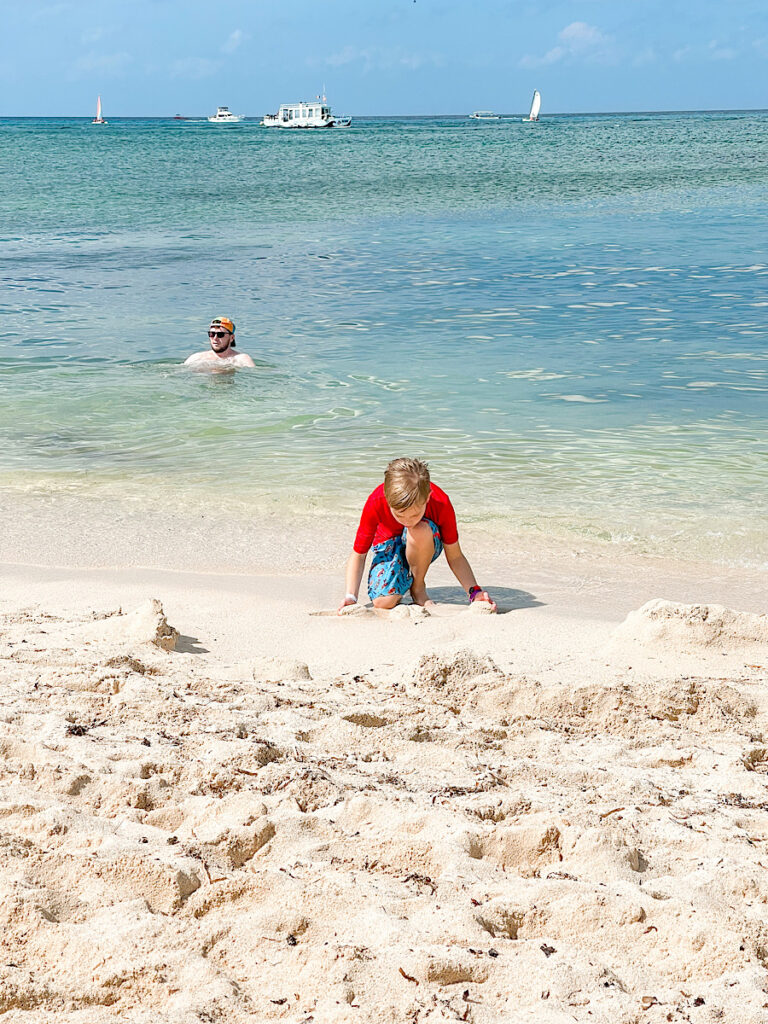 A boy playing in the sand at Playa Mia Beach Club, a cruise excursion in Cozumel.