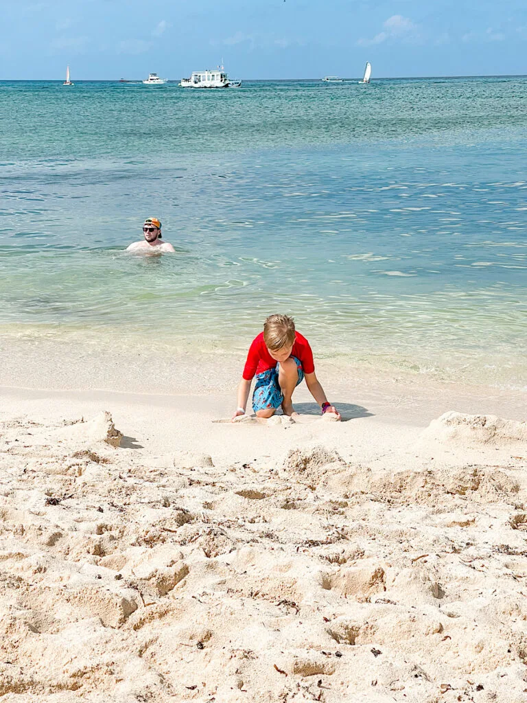 A boy playing in the sand at Playa Mia Beach Club, a cruise excursion in Cozumel.