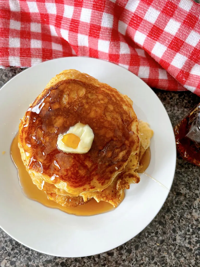 Sour cream pancakes with butter and syrup.