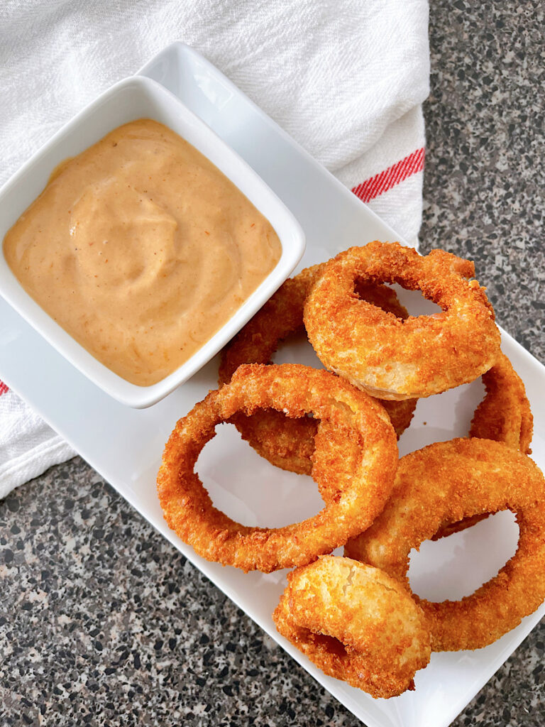Air fryer Red Robin onion rings and a dish or Campfire sauce.