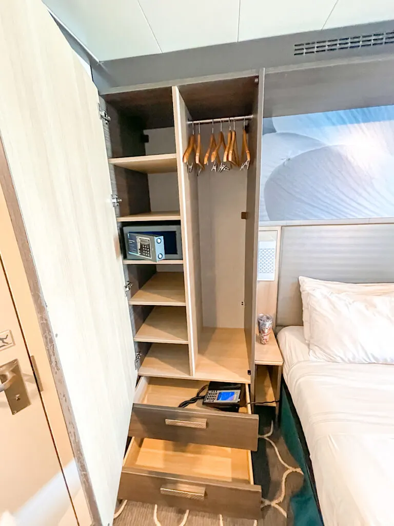 Closet one of Stateroom 7666 on Harmony of the Seas with shelves and drawers.