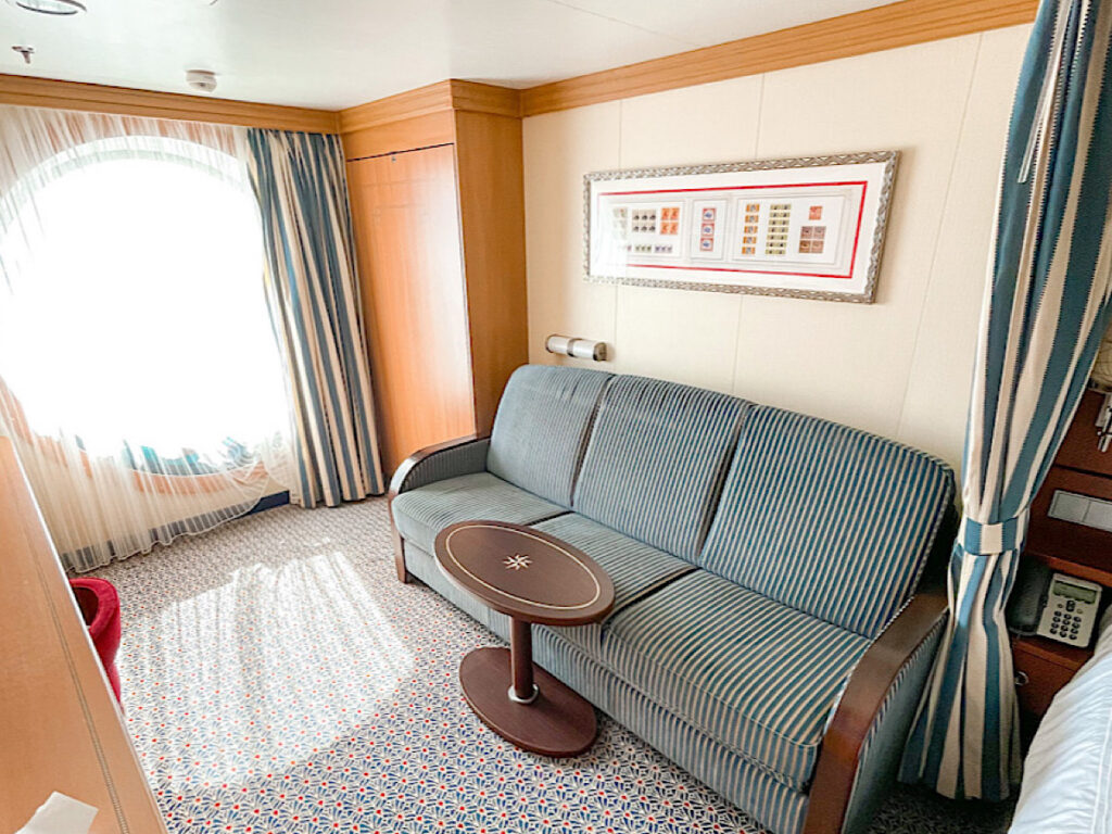 Couch and porthole in Disney Dream Stateroom 9504.