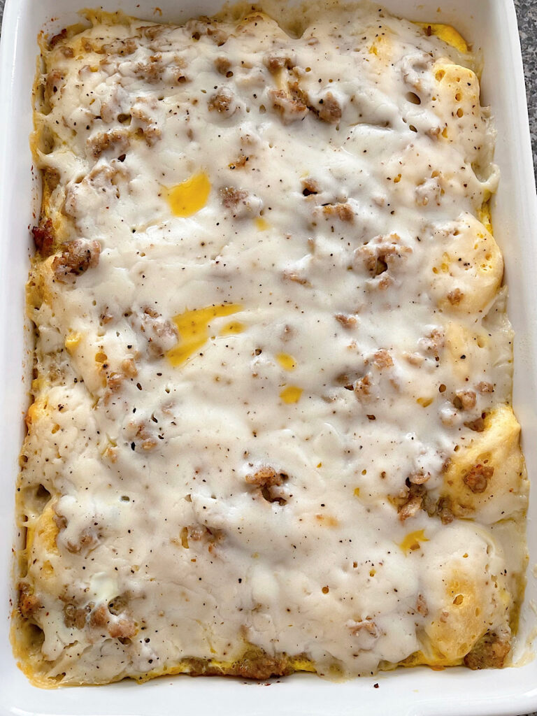 Baked biscuits and gravy in a baking dish.