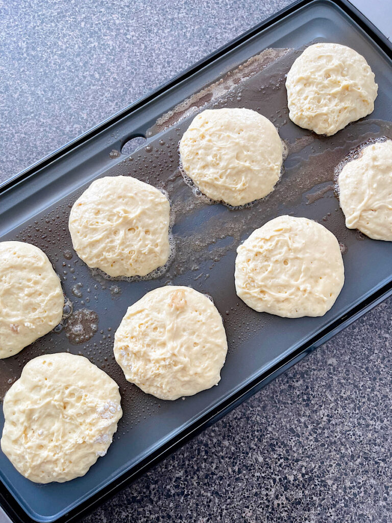 Sour cream pancakes on a hot griddle.