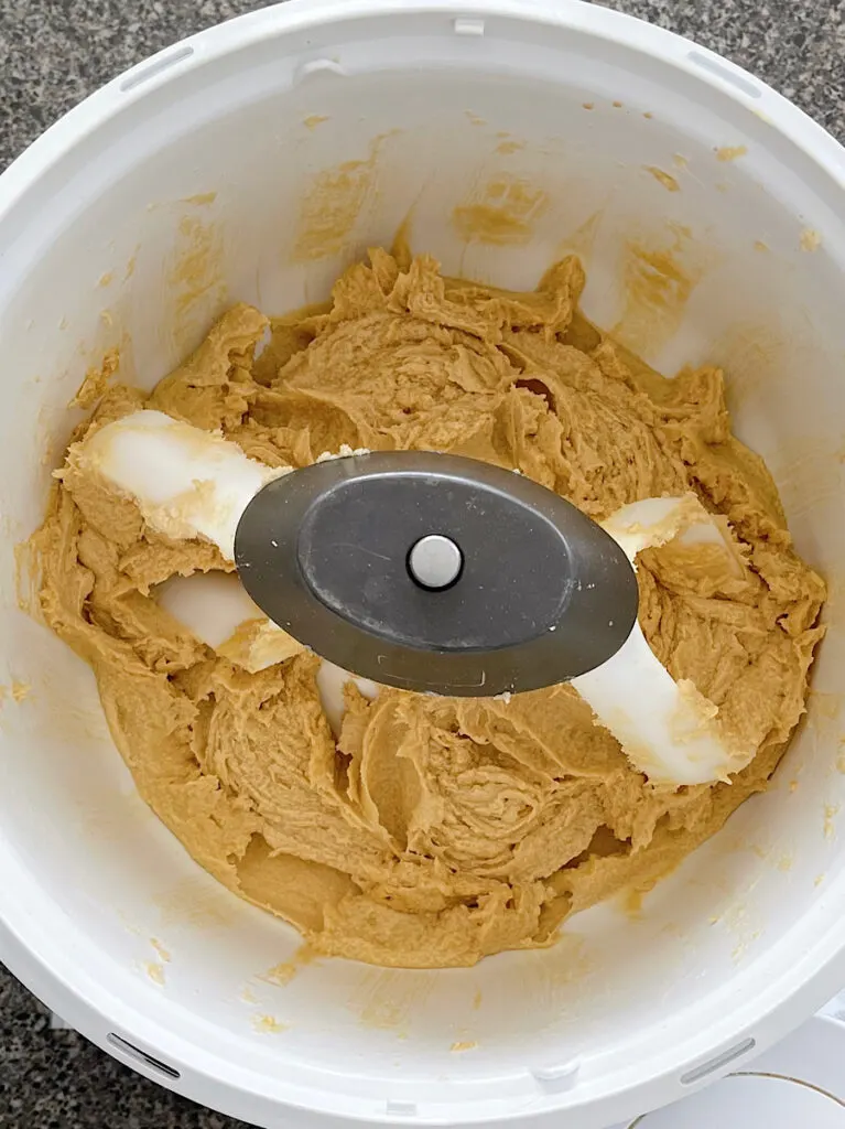 Crumbl chocolate chip cookie dough in a stand mixer.
