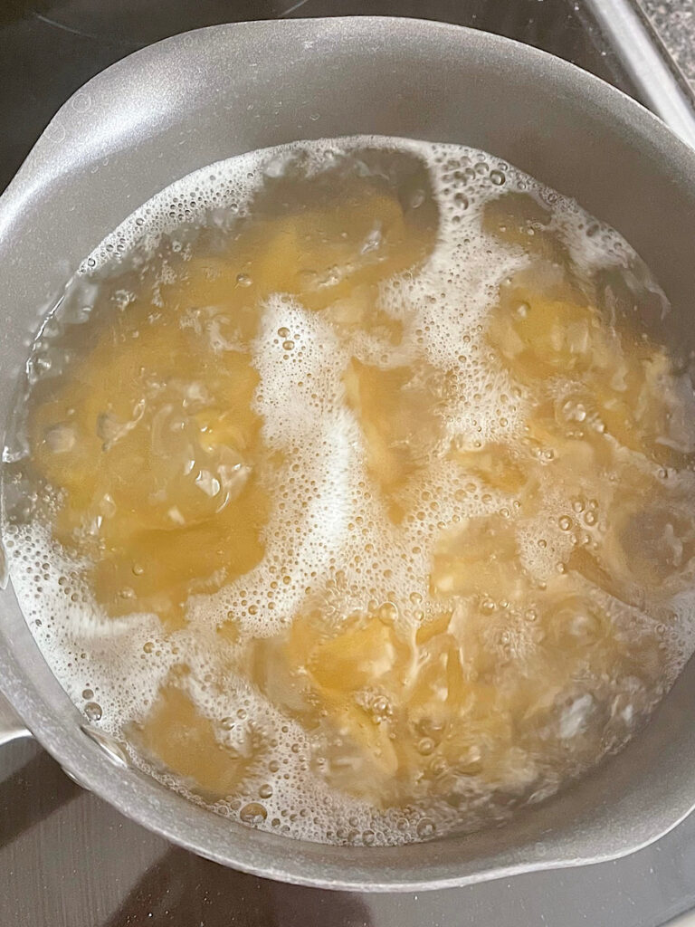 Penne pasta boiling in a pot.