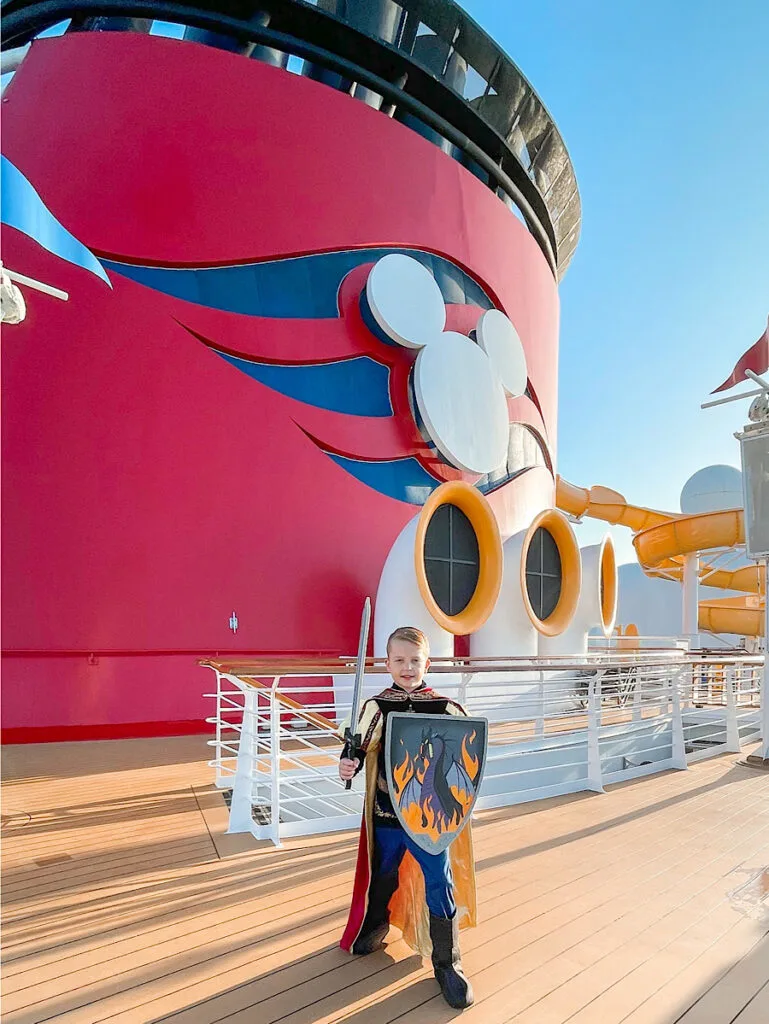 A boy in a knight costume from the Bibbidi Bobbidi Boutique on a Disney Cruise.
