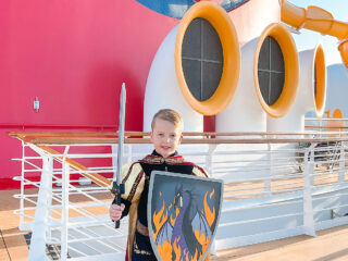 A boy in a knight costume from the Bibbidi Bobbidi Boutique on a Disney Cruise.