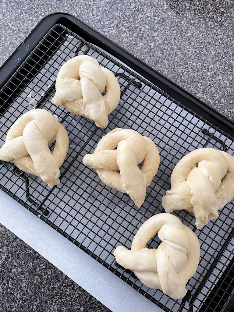 Pretzels on a wire rack about to be air fried.