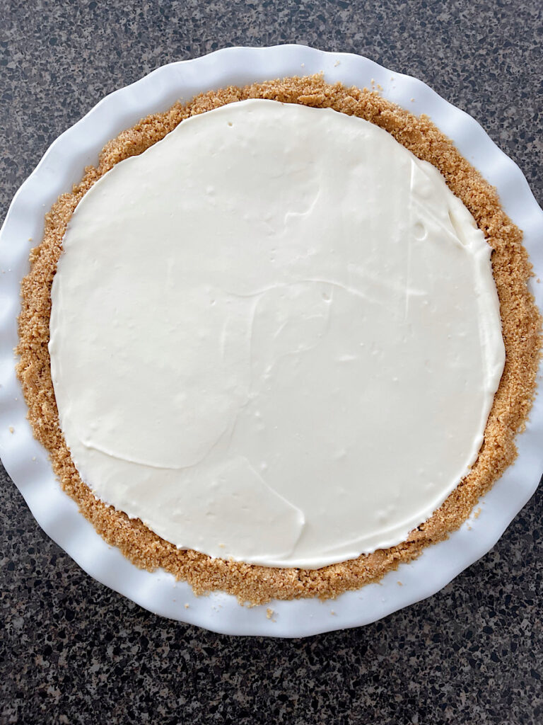 A no bake key lime pie in a white pie pan.