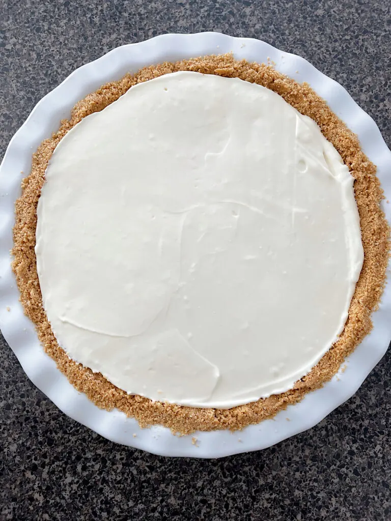 A no bake key lime pie in a white pie pan.