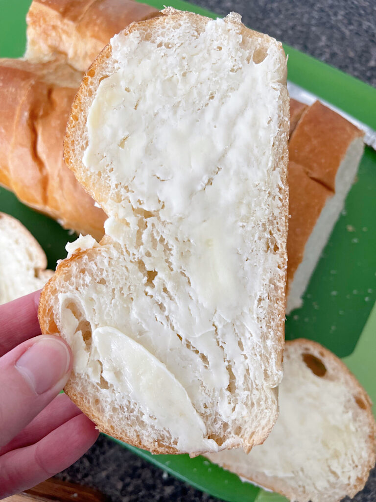 A slice of bread covered in butter.