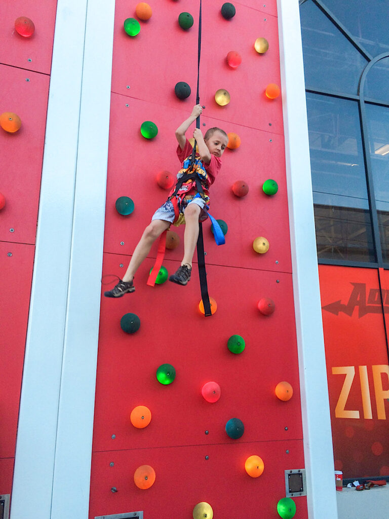 A boy on a climbing wall in Belmont Park in San Diego, California.