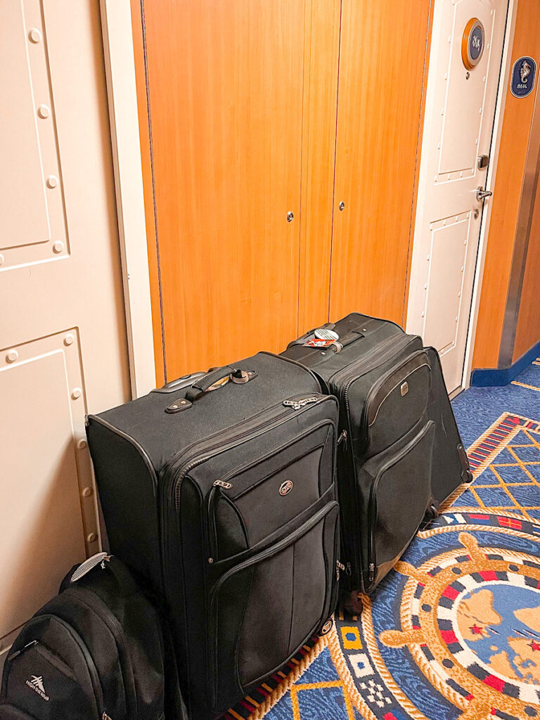 Suitcases outside a stateroom cabin on a Disney cruise.