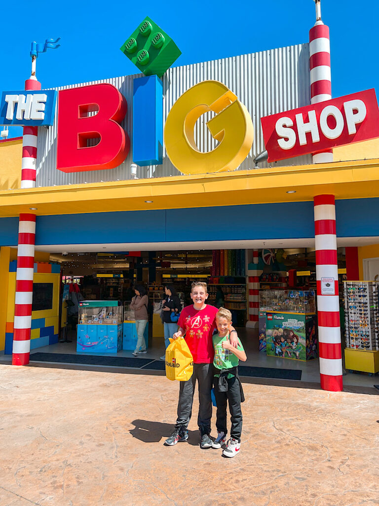 Two kids standing outside the gift shop at LEGOLAND California.