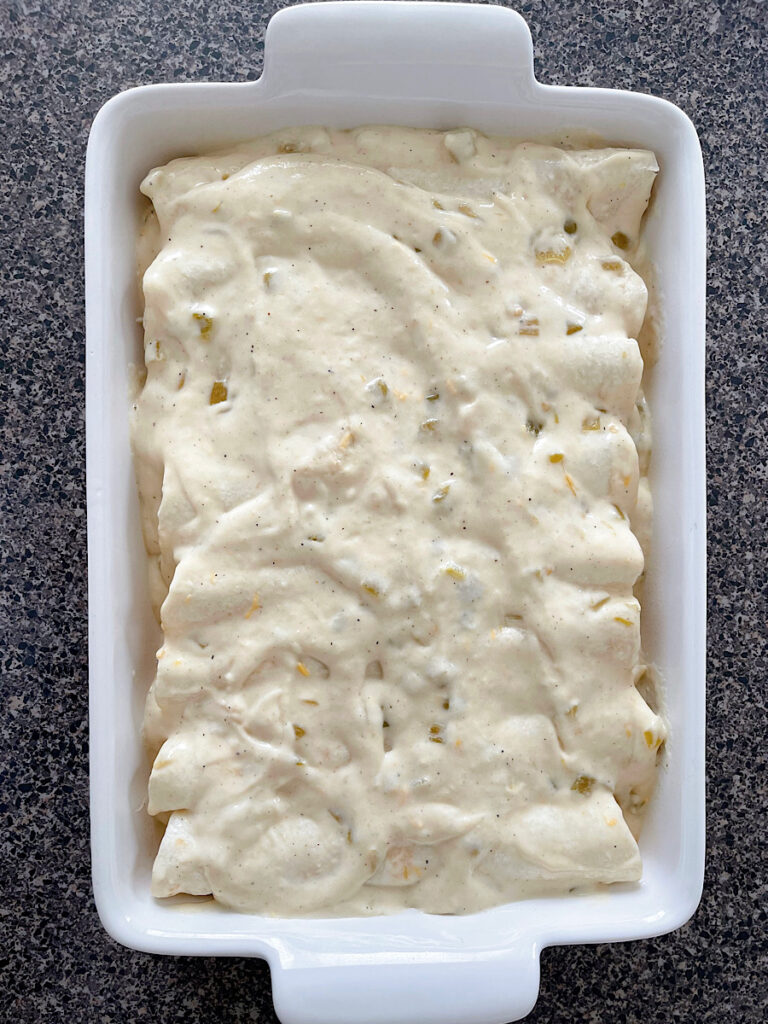 A pan full of sour cream chicken enchiladas.