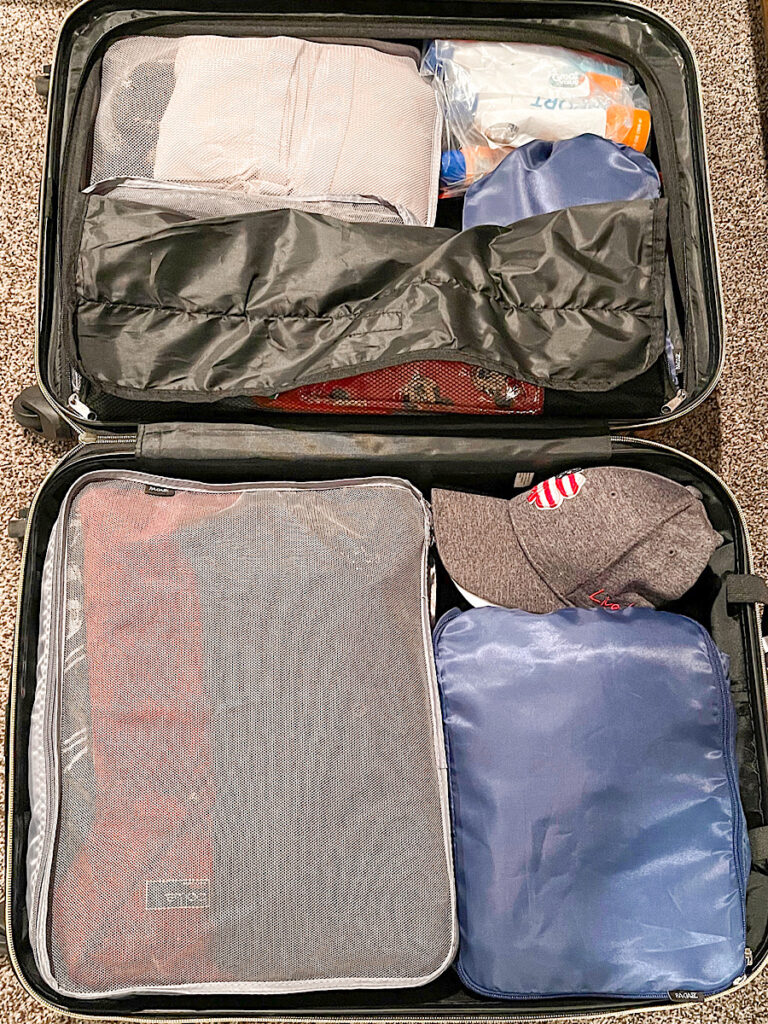 A suitcase packed with packing cubes.
