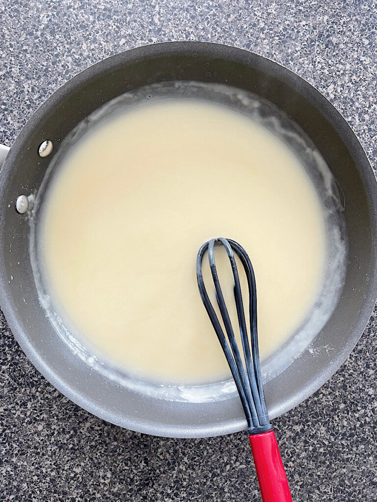 Sour cream enchilada sauce in a pan.