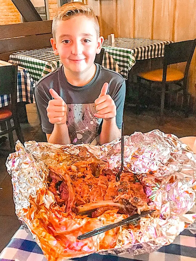 A child with a giant serving of ribs at Portillo's in Buena Park.