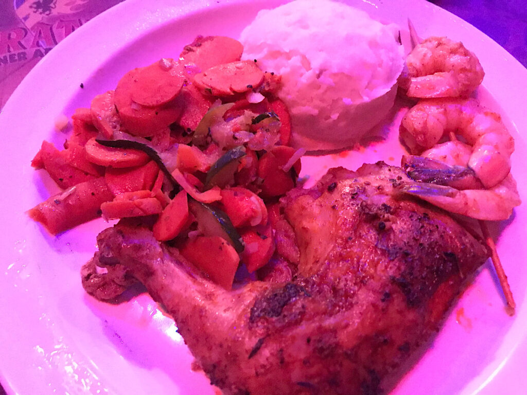 Dinner plate with roast chicken served at Pirate Dinner Adventure in Buena Park, California.