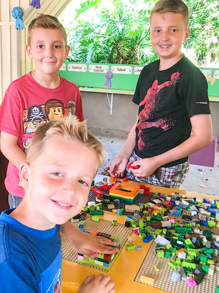 Three kids playing with LEGO bricks at Legoland California.