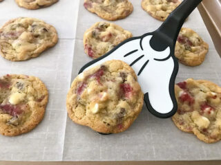 Raspberry white chocolate chip cookies on a Mickey Mouse spatula.