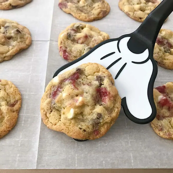 Raspberry white chocolate chip cookies on a Mickey Mouse spatula.