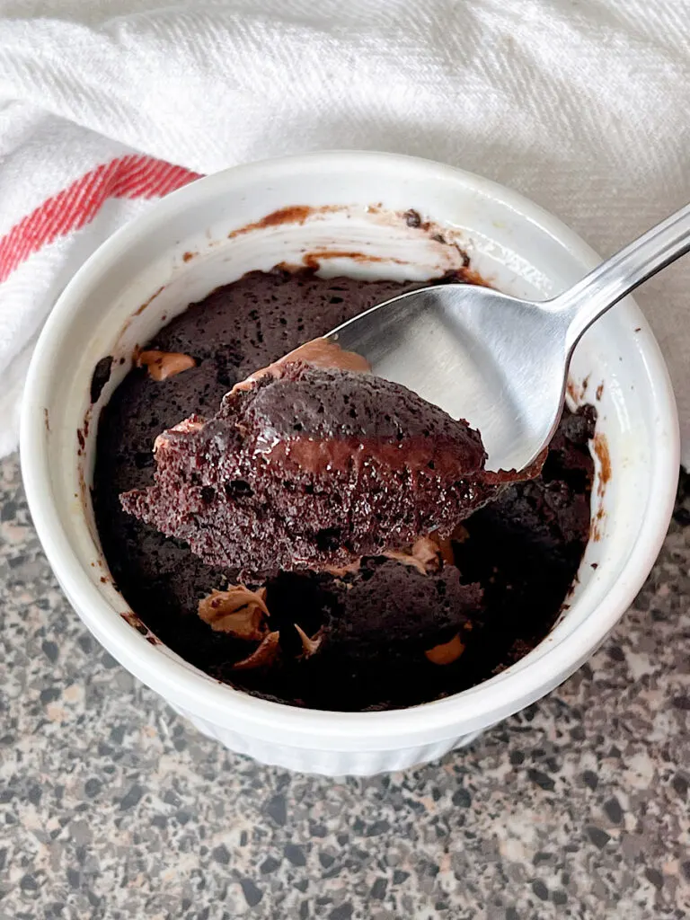 A spoonful of chocolate Nutella mug cake.