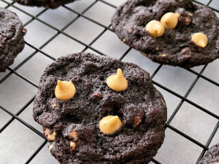 Reese's Chocolate Peanut Butter Chip Cookies on a cooling rack.