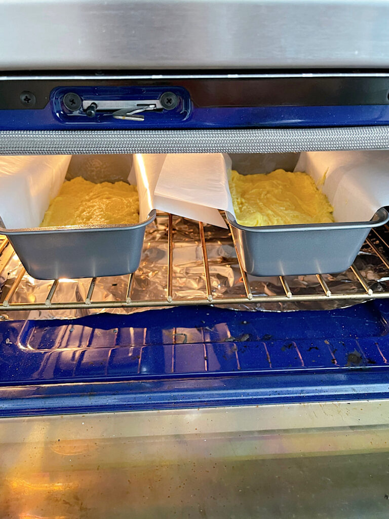 Two loaves of lemon bread in an oven.