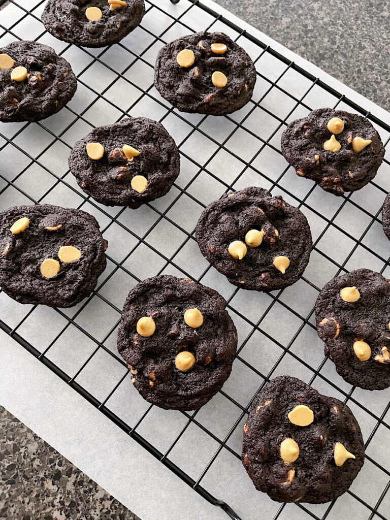 Chocolate peanut butter chip cookies on a cooling rack.