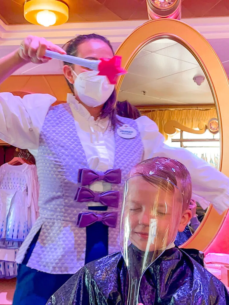 A child at the Bibbidi Bobbidi Boutique on a Disney Cruise.