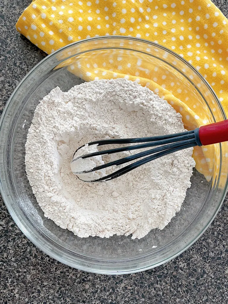 Flour mixture in a glass bowl to make cinnamon banana muffins.