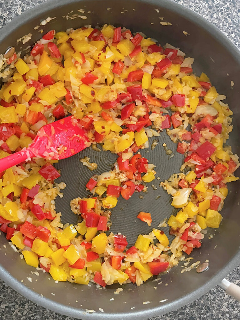 Bell peppers and onions in a pan.