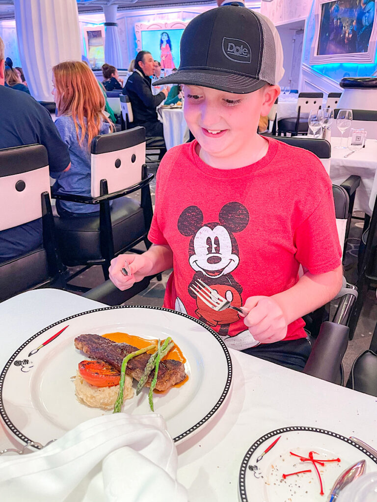 A child eating a meal on a Disney Cruise.