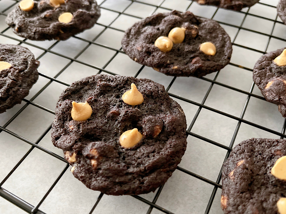 Reese's Chocolate Peanut Butter Chip Cookies on a cooling rack.