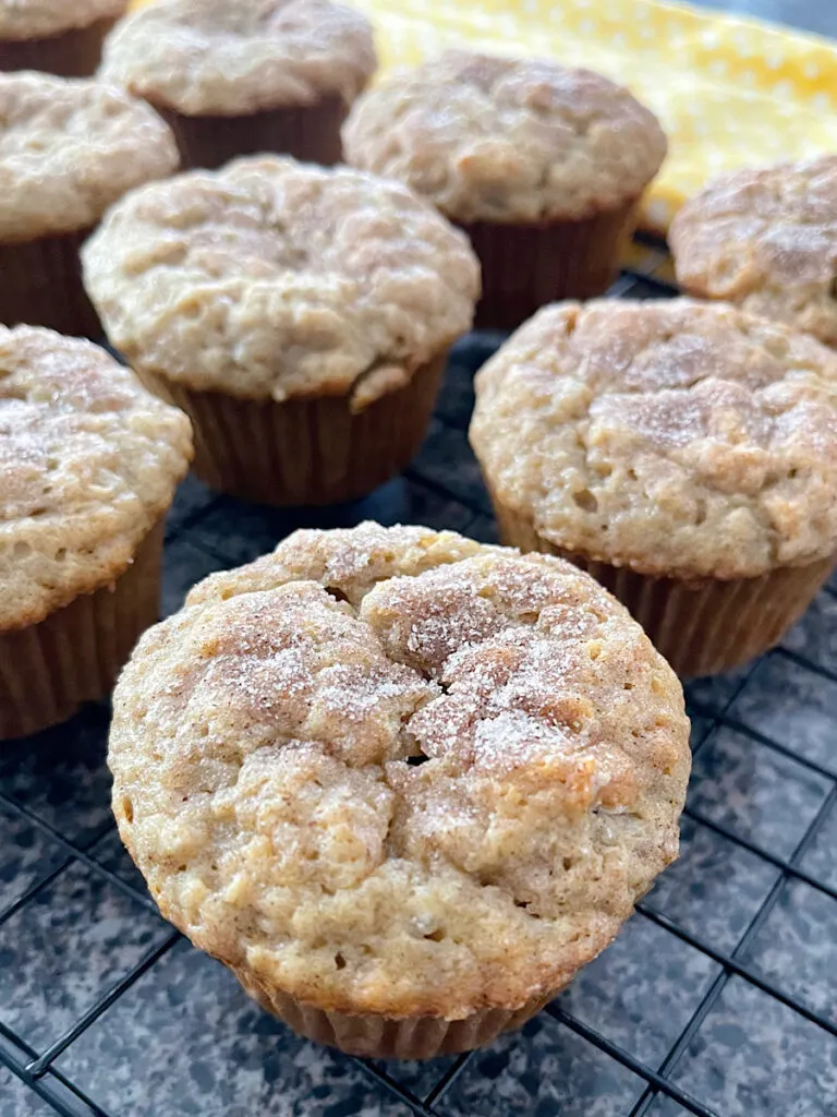 Banana cinnamon muffins on a wire cooling rack.