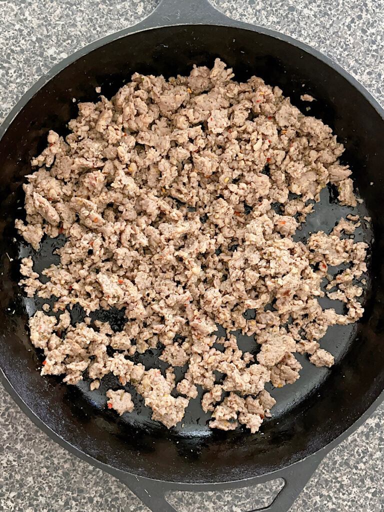 Cooked ground sausage in a skillet.