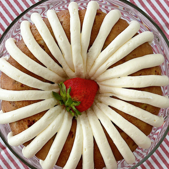 A strawberry bunt cake with white chocolate frosting.