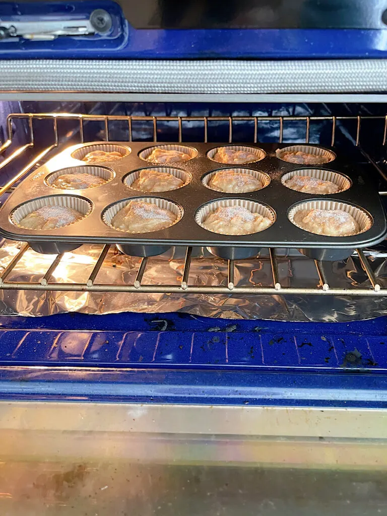 A pan of cinnamon banana muffins in the oven.