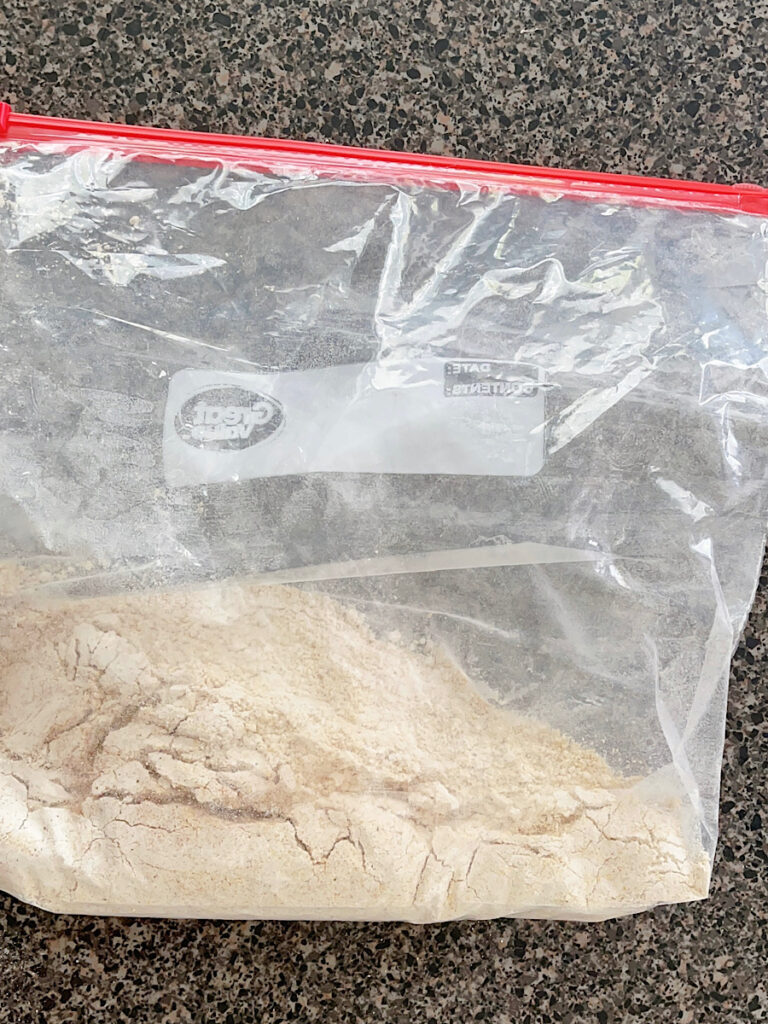Flour, cornmeal, breadcrumbs, and seasonings in a ziplock bag.