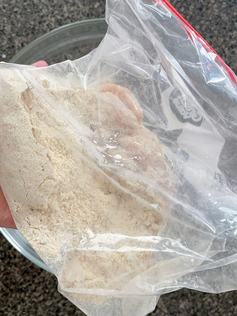 Chicken strips in a ziplock bag with seasonings.