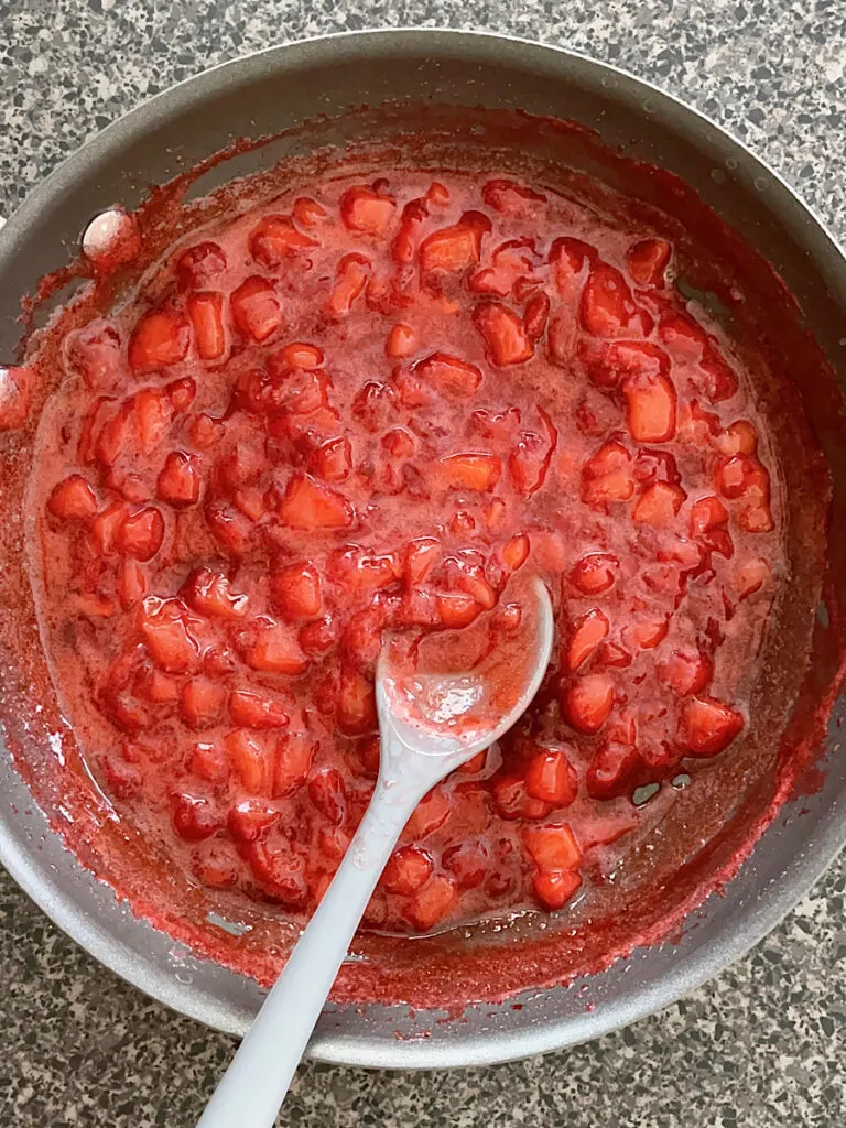 Strawberry sauce in a sauce pan.