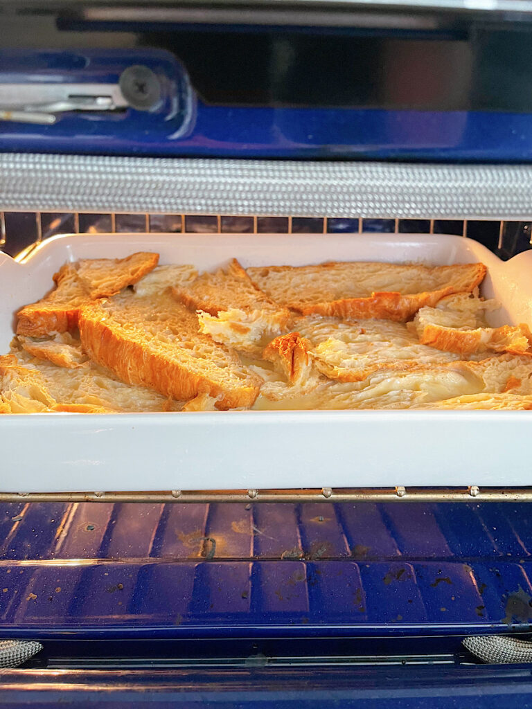 A croissant French toast casserole in the oven.