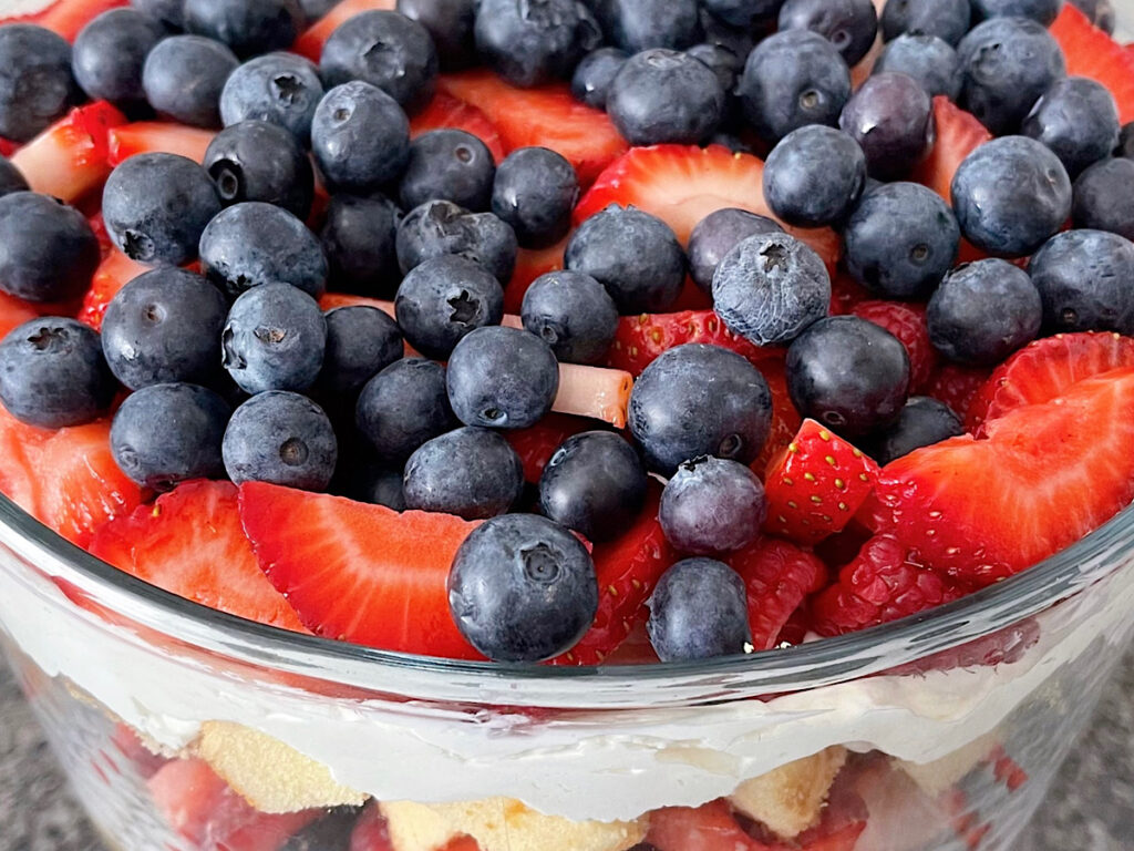 Raspberries, blueberries, and strawberries on top of a 4th of July trifle.