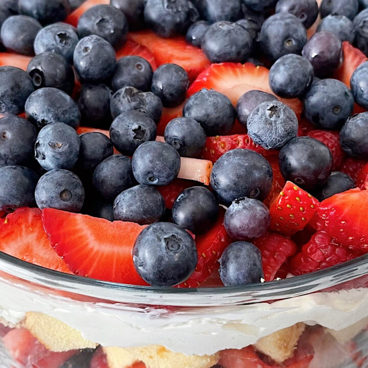 Raspberries, blueberries, and strawberries on top of a 4th of July trifle.