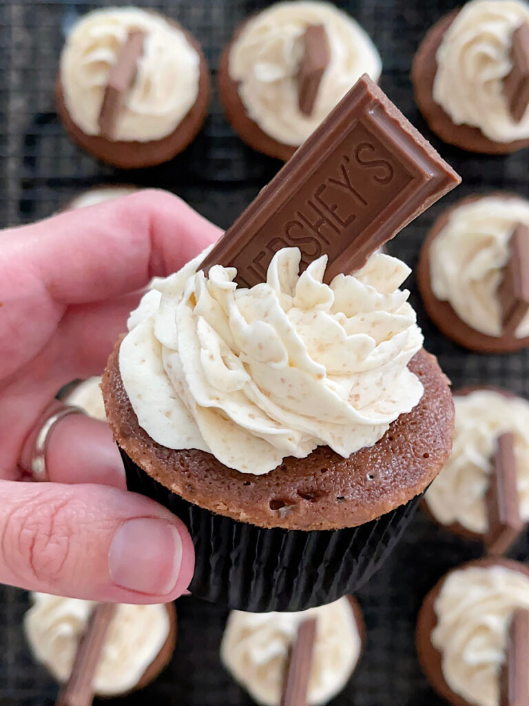 A s'mores cupcake with graham cracker frosting and a piece of Hershey's chocolate bar.