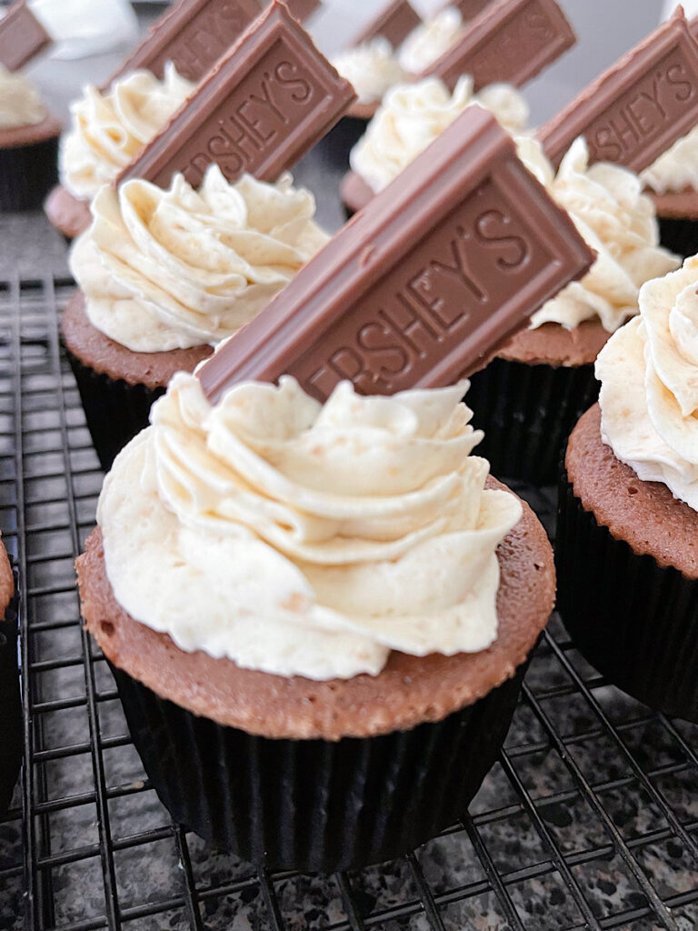 A s'mores cupcake with graham cracker frosting and a piece of Hershey's chocolate bar.