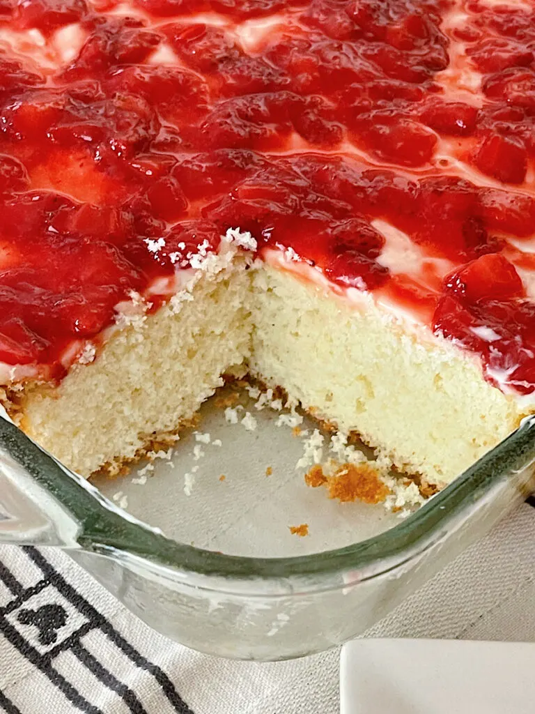 A strawberry cream cake in a cake pan.